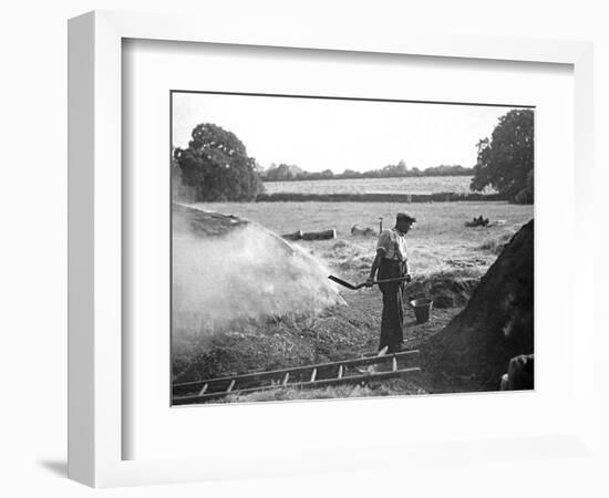 A Farmer Holding a Shovel on a Farm in England, 1938-null-Framed Photographic Print