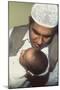 A Father Whispers the Opening Words of the Muslim Shahada in His Newborn Baby's Ear-null-Mounted Photographic Print