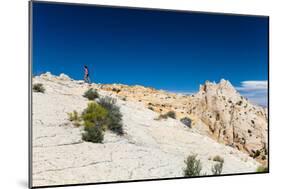 A Female Hiker Walks On Beautiful White Slickrock On Lower Muley Twist Trail In Capitol Reef NP-Ben Herndon-Mounted Photographic Print