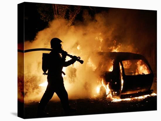 A Firefighter Extinguishes a Car in Les Musicians-null-Stretched Canvas