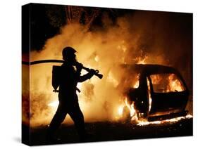 A Firefighter Extinguishes a Car in Les Musicians-null-Stretched Canvas