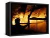 A Firefighter Tries to Extinguish a Raging Fire-null-Framed Stretched Canvas