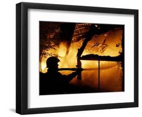 A Firefighter Tries to Extinguish a Raging Fire-null-Framed Photographic Print