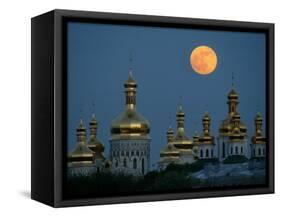 A Full Moon Rises in the Night Sky During a Lunar Eclipse-null-Framed Stretched Canvas