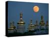 A Full Moon Rises in the Night Sky During a Lunar Eclipse-null-Stretched Canvas