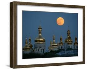 A Full Moon Rises in the Night Sky During a Lunar Eclipse-null-Framed Photographic Print