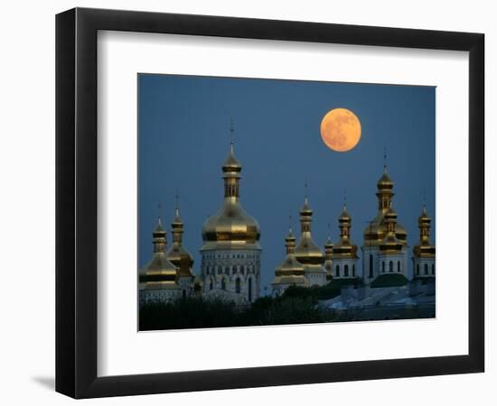 A Full Moon Rises in the Night Sky During a Lunar Eclipse-null-Framed Photographic Print