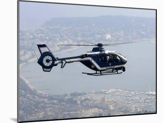 A Gendarme Helicopter is Seen Above the Bay of Cannes-Michel Spingler-Mounted Premium Photographic Print