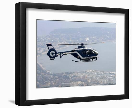 A Gendarme Helicopter is Seen Above the Bay of Cannes-Michel Spingler-Framed Photographic Print