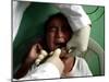 A Girl, 6, Cries as Dentist Allan Castellanos Removes a Molar Toot-null-Mounted Premium Photographic Print