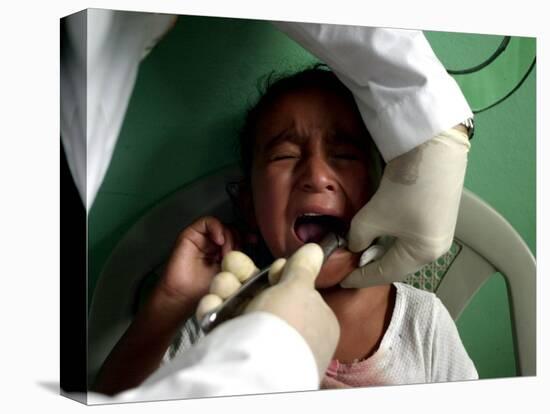 A Girl, 6, Cries as Dentist Allan Castellanos Removes a Molar Toot-null-Stretched Canvas