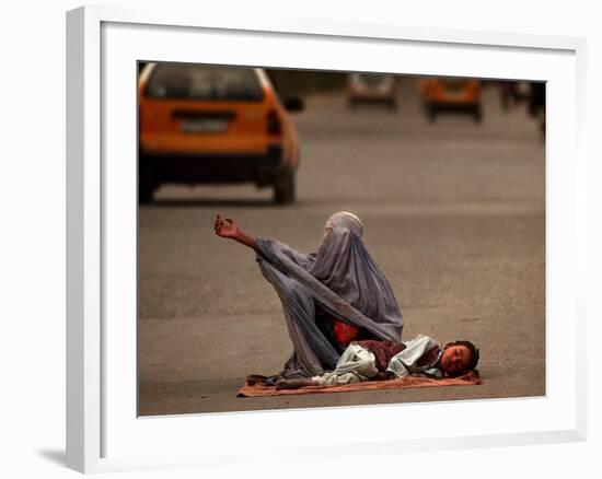 A Girl, 7, Sick with Fever, Lies on a Street-null-Framed Photographic Print