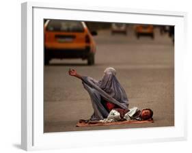 A Girl, 7, Sick with Fever, Lies on a Street-null-Framed Photographic Print