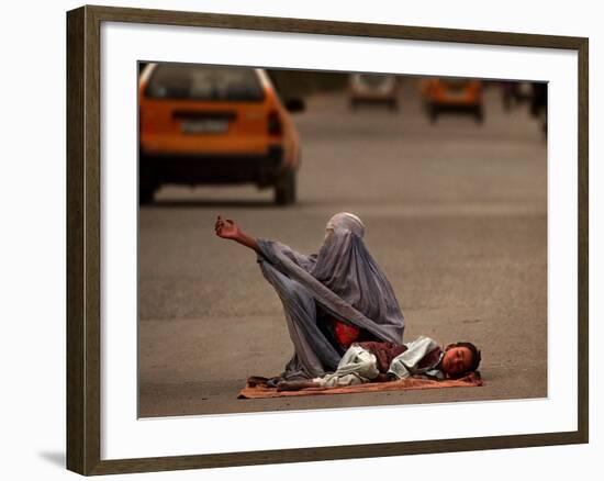 A Girl, 7, Sick with Fever, Lies on a Street-null-Framed Photographic Print