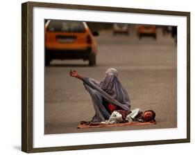 A Girl, 7, Sick with Fever, Lies on a Street-null-Framed Photographic Print