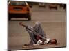 A Girl, 7, Sick with Fever, Lies on a Street-null-Mounted Photographic Print