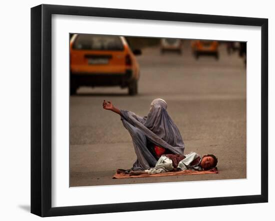 A Girl, 7, Sick with Fever, Lies on a Street-null-Framed Photographic Print