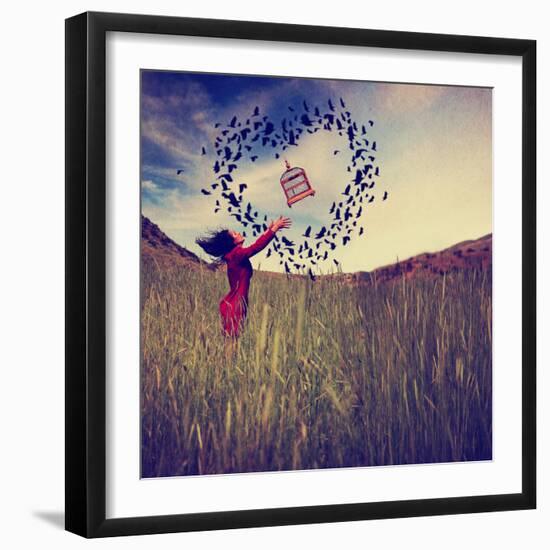 A Girl in a Field Tossing a Birdcage in the Air with Birds Flying in the Shape of a Heart Toned Wit-graphicphoto-Framed Photographic Print
