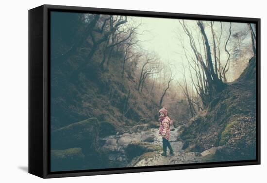 A Girl on a Boulder Looking Towards Camera-Clive Nolan-Framed Stretched Canvas