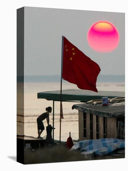 A Girl Rests on a Boat Below the Chinese National Flag-null-Stretched Canvas