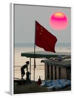 A Girl Rests on a Boat Below the Chinese National Flag-null-Framed Photographic Print