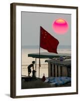 A Girl Rests on a Boat Below the Chinese National Flag-null-Framed Photographic Print