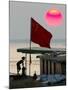 A Girl Rests on a Boat Below the Chinese National Flag-null-Mounted Photographic Print