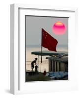 A Girl Rests on a Boat Below the Chinese National Flag-null-Framed Photographic Print