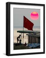 A Girl Rests on a Boat Below the Chinese National Flag-null-Framed Photographic Print