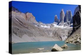 A glacial lake and the rock towers that give the Torres del Paine range its name, Torres del Paine-Alex Robinson-Stretched Canvas