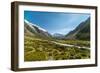A glacier fed creek cuts through a green valley high in the mountains, South Island, New Zealand-Logan Brown-Framed Photographic Print