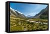 A glacier fed creek cuts through a green valley high in the mountains, South Island, New Zealand-Logan Brown-Framed Stretched Canvas