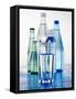 A Glass in Front of Mineral Water Bottles-Alexander Feig-Framed Stretched Canvas