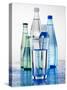 A Glass in Front of Mineral Water Bottles-Alexander Feig-Stretched Canvas
