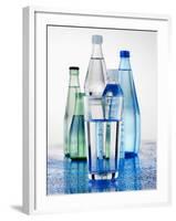 A Glass in Front of Mineral Water Bottles-Alexander Feig-Framed Photographic Print
