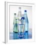 A Glass in Front of Mineral Water Bottles-Alexander Feig-Framed Photographic Print