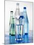 A Glass in Front of Mineral Water Bottles-Alexander Feig-Mounted Photographic Print