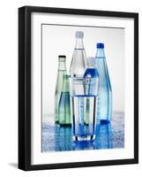 A Glass in Front of Mineral Water Bottles-Alexander Feig-Framed Photographic Print