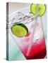 A Glass of Raspberry Soda with Ice Cubes and Lime Slices-null-Stretched Canvas