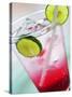 A Glass of Raspberry Soda with Ice Cubes and Lime Slices-null-Stretched Canvas