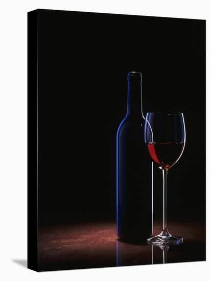 A Glass of Red Wine and a Wine Bottle-Roland Krieg-Stretched Canvas