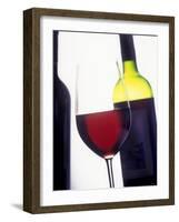 A Glass of Red Wine with a Bottle in the Background-Armin Faber-Framed Photographic Print