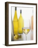 A Glass of White Wine and Wine Bottles in Background-Ulrike Koeb-Framed Photographic Print