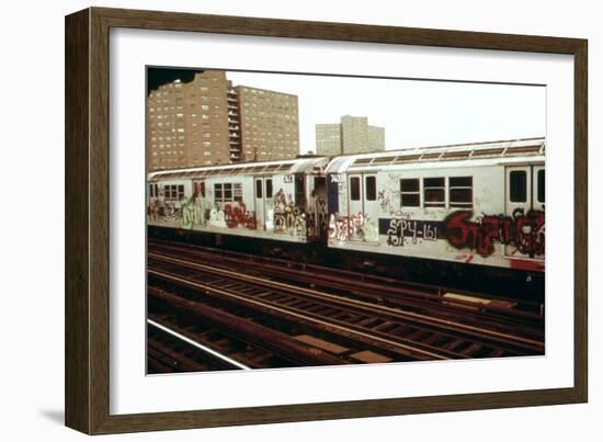 A Graffiti Painted Subway Train with Housing Projects in the Background, May 1973-null-Framed Photo