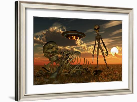 A Grey Alien Looking at Humanoid Remains as a Ufo Flys Overhead-Stocktrek Images-Framed Art Print