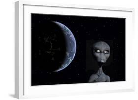 A Grey Alien with Planet Earth in the Background-null-Framed Art Print