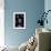 A Grey Alien-null-Framed Art Print displayed on a wall