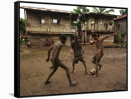 A Group of Panamanian Youths Slide Through the Mud During a Pick-Up Game of Soccer-null-Framed Stretched Canvas
