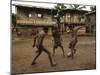 A Group of Panamanian Youths Slide Through the Mud During a Pick-Up Game of Soccer-null-Mounted Premium Photographic Print