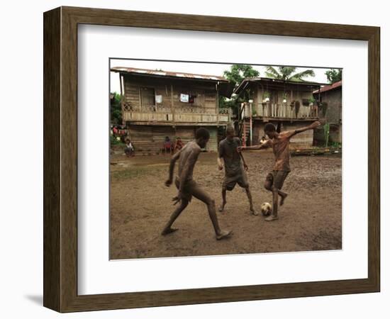 A Group of Panamanian Youths Slide Through the Mud During a Pick-Up Game of Soccer-null-Framed Photographic Print